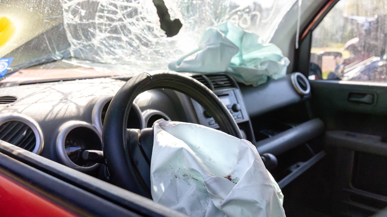 Inflated airbag and broken windshield of a car