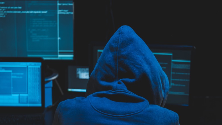hacker facing computer screens