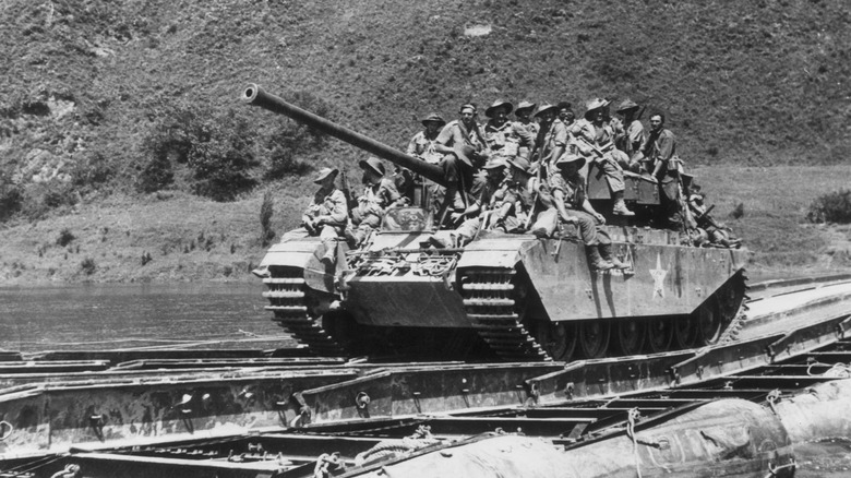 3rd Battalion Royal Australian Regiment crowded onto a Centurion tank after crossing the Injim River in Korea