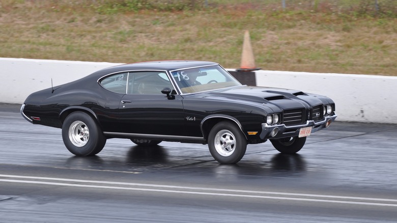 black car drag racing on track