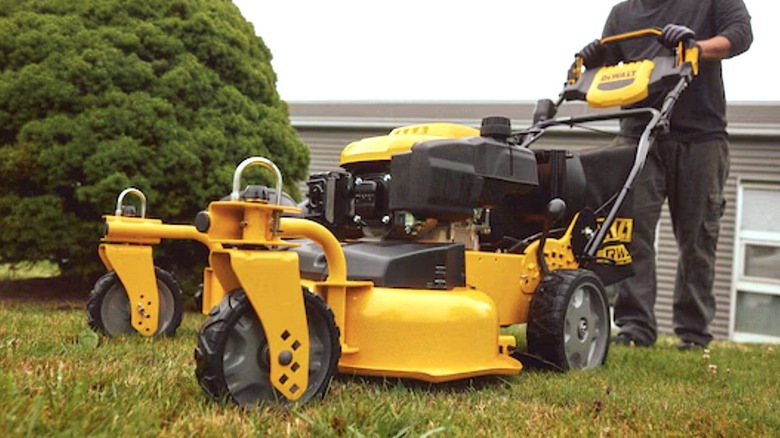 Person using DeWalt's 28-inch 3-in-1 Lawn Mower