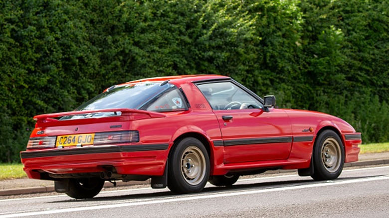 Red Mazda RX-7 on road