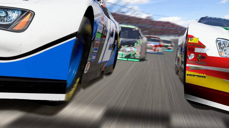 Racing stock cars in action showing air dams at the front of each vehicle