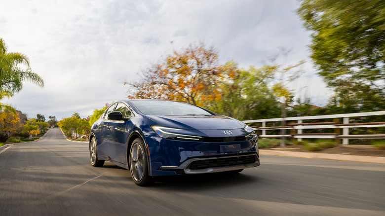 Front shot of a blue Toyota Prius driving