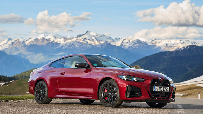 Side shot of a 2025 BMW 4 Series coupe against a mountain backdrop