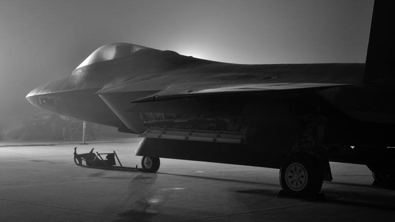 F22 Raptor pictured at night on a runway