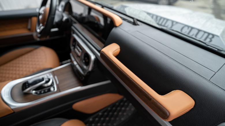 An image of a Mercedes Benz G Class interior with the dashboard grab handle in focus.