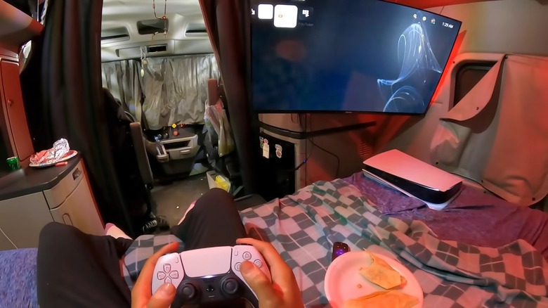 A Trucker Eating And Playing PS5 In A Semi Sleeper