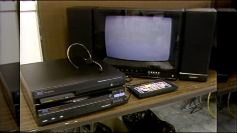 An RDI Halcyon system set up with a LaserDisc machine, CRT TV, speakers, headset, and accompanying keyboard
