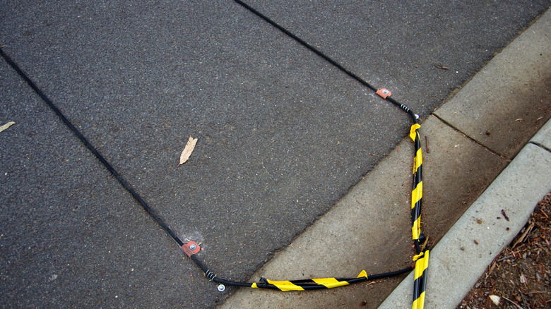 Pneumatic road tubes attached to a road