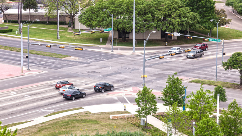 Cars pulled up to a large four-way intersection