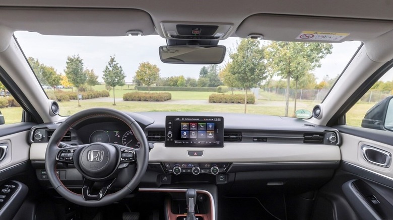 A driver's view photo of the inside of a Honda EV, including the wheel, dash, and windshield.