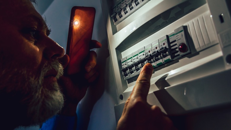 person resetting circuit breaker