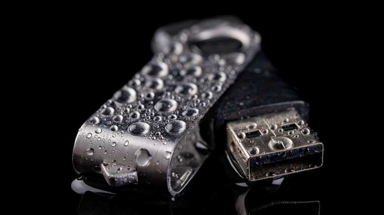 a wet USB drive on a black background