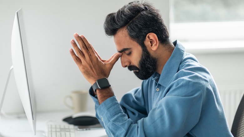 Frustrated man wearing Apple watch