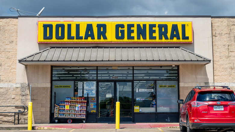 Red Car parking in front of Dollar General store