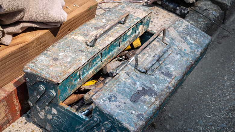 A rusty toolbox on the ground