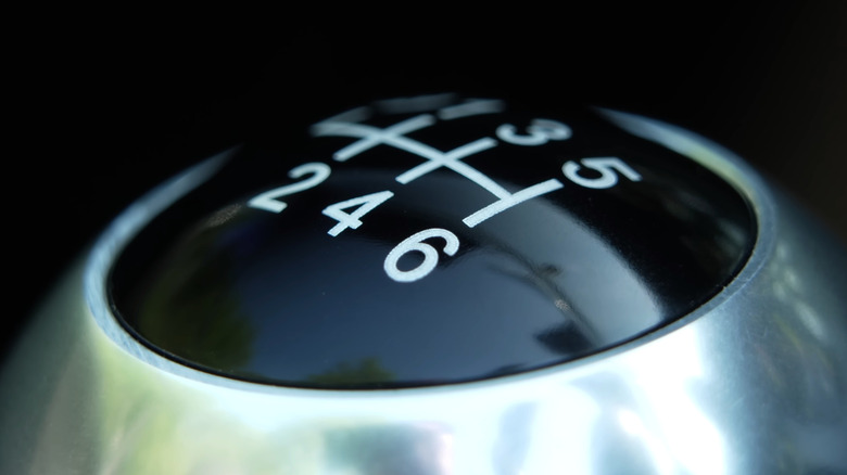 Close-up of six-speed manual shifter knob, focusing on sixth gear
