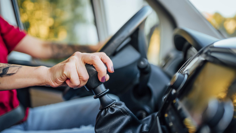 Close-up of person shifting gears in manual transmission-equipped Ford Transit van