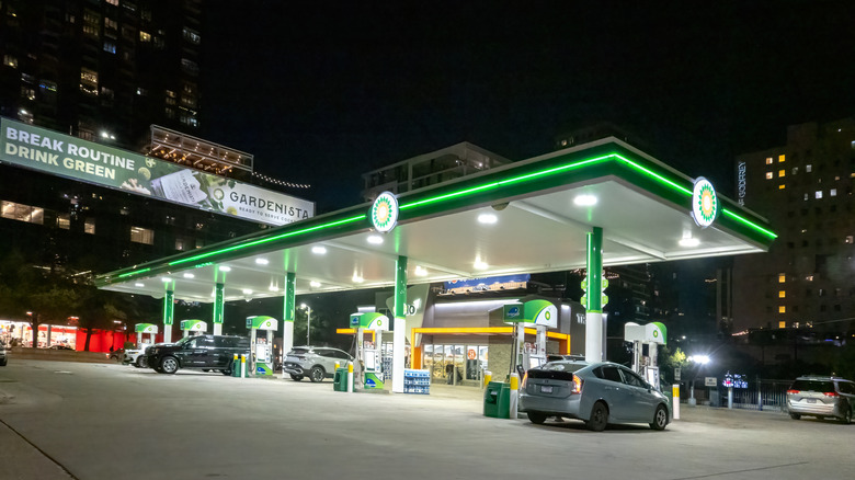 Gas station in urban nighttime environment servicing passenger cars