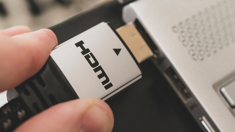 Person holding an HDMI connector