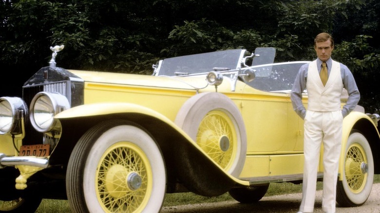 Robet Redford standing next to Rolls-Royce