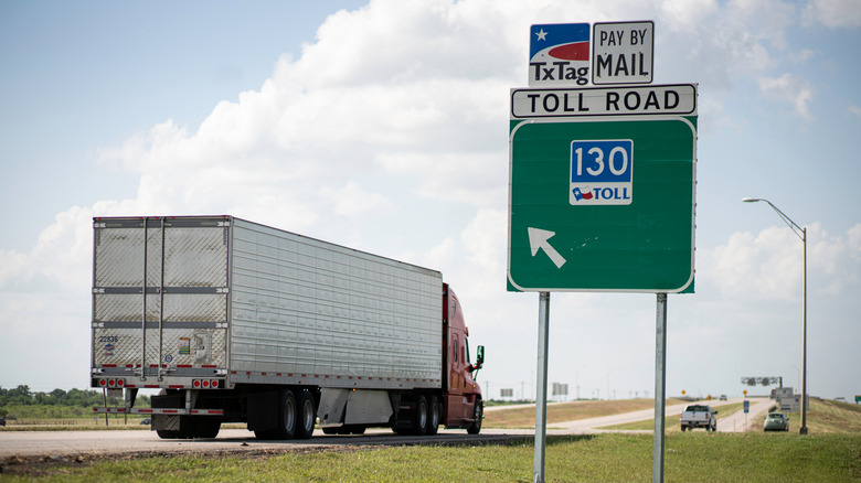 Truck passing a sign for State Highway 130