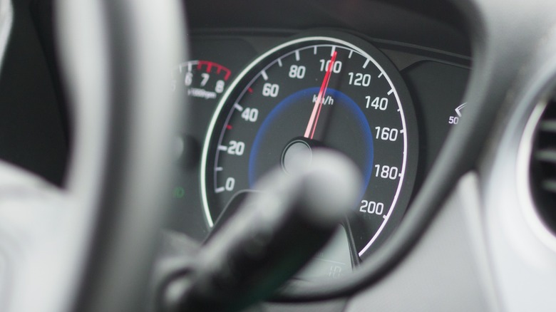 a car driving at 100 kph as seen on the speedometer