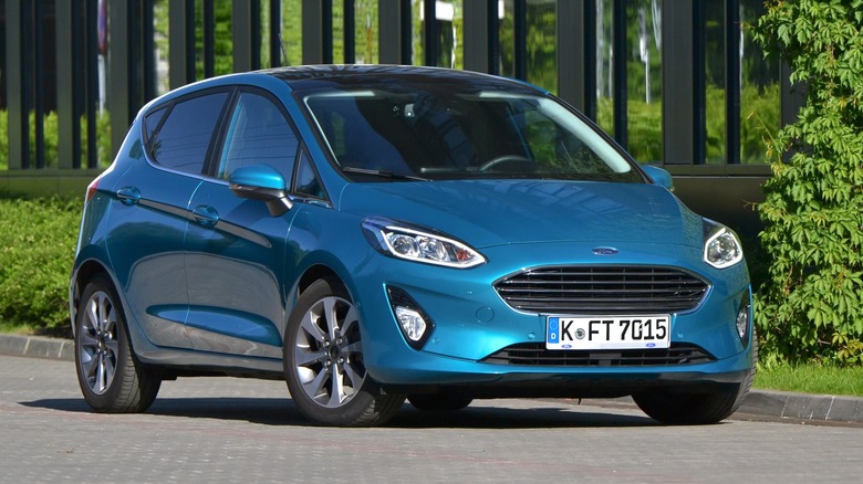 A blue Ford Fiesta model on the street