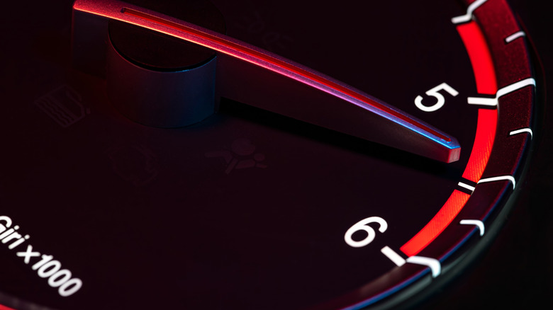 Rev counter needle approaching the redline, indicating high engine rpm.