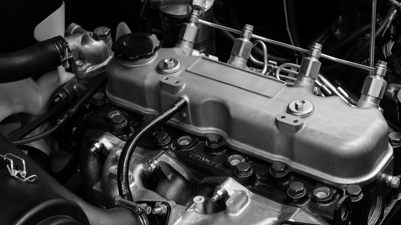 four-cylinder diesel engine showing valve cover and exhaust manifold