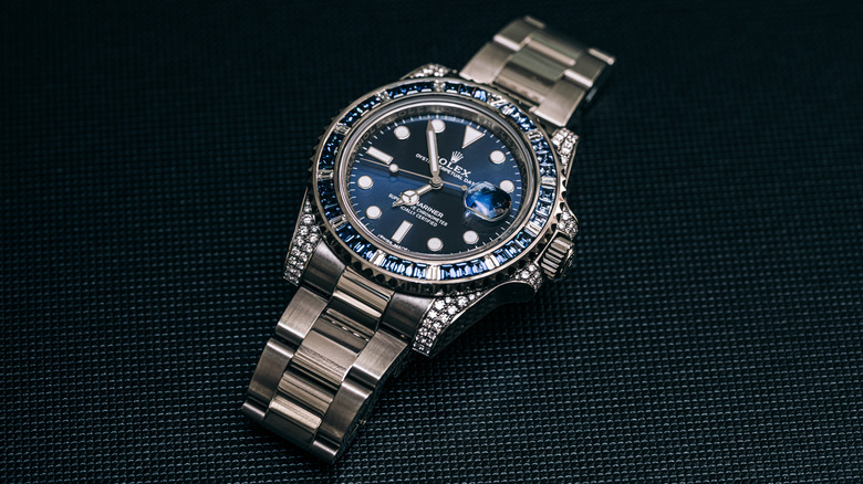 A Rolex Submariner on a black background