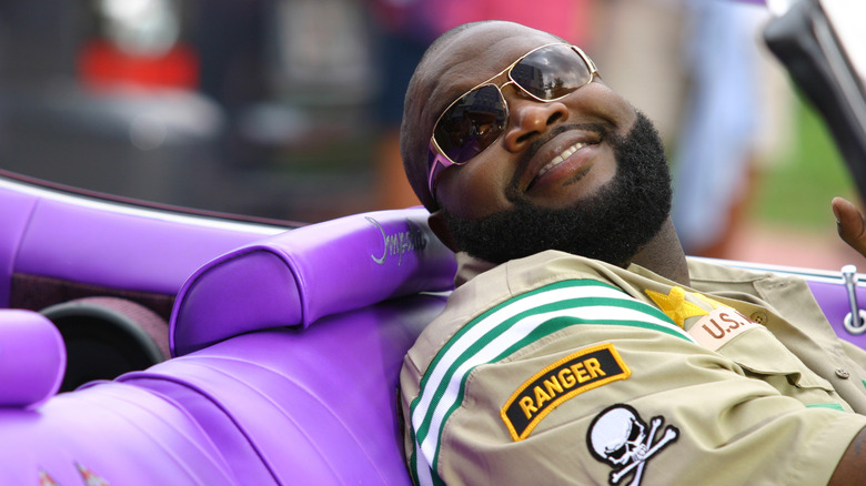 Rick Ross smiling in convertible