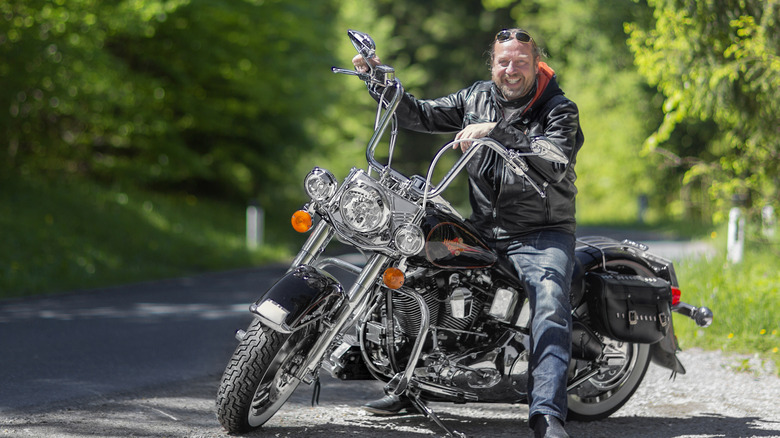 An aged man on his Harley Davidson in Alps.