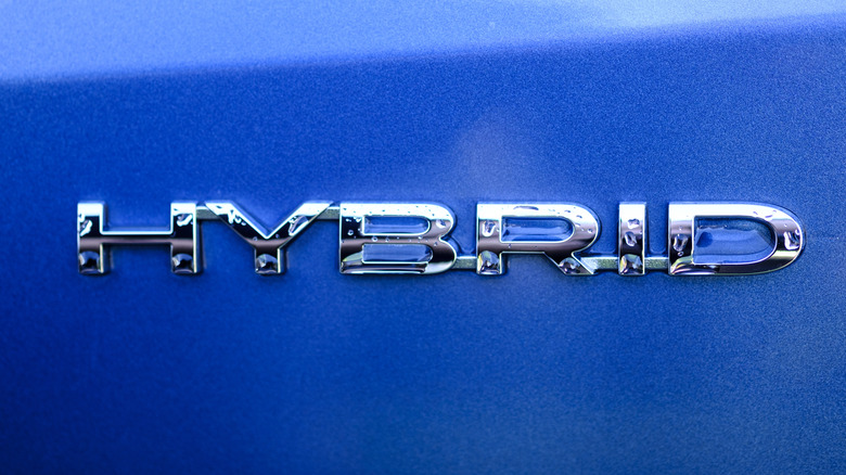 Hybrid car badge over blue paint
