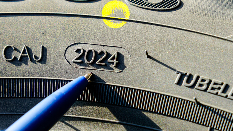 A tire with yellow dot and year mentioned