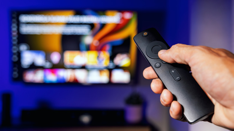 Fire TV Stick remote pointed to a TV