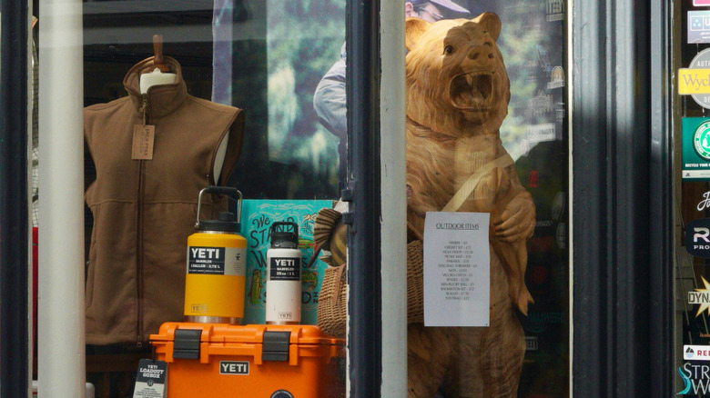 A look inside a Yeti store with products on display and a Yeti for decoration