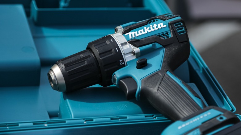 Makita power drill teal plastic background