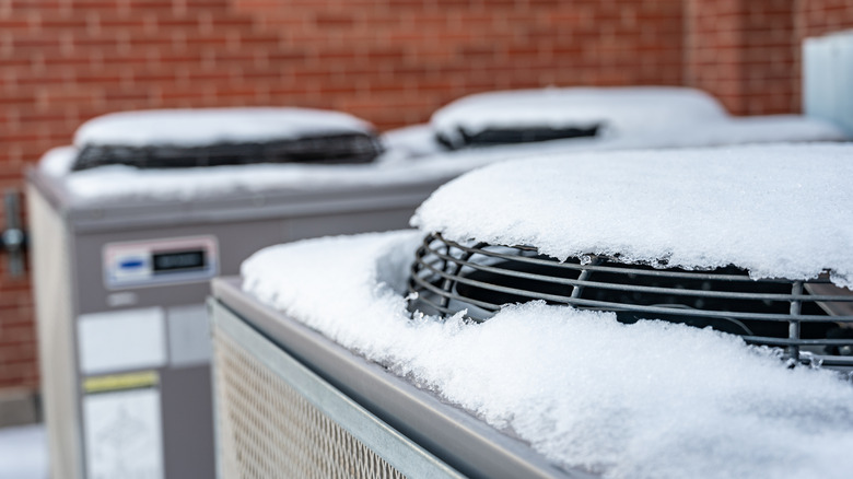 Snow melting on top of an HVAC unit
