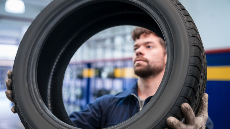 Mechanic holds tire