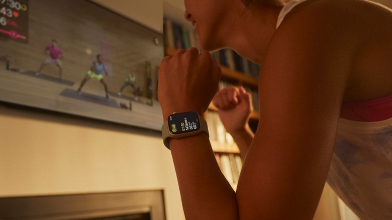 Woman wearing Apple Watch while doing home workout