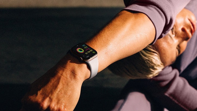 Woman wearing Apple Watch while using doing yoga