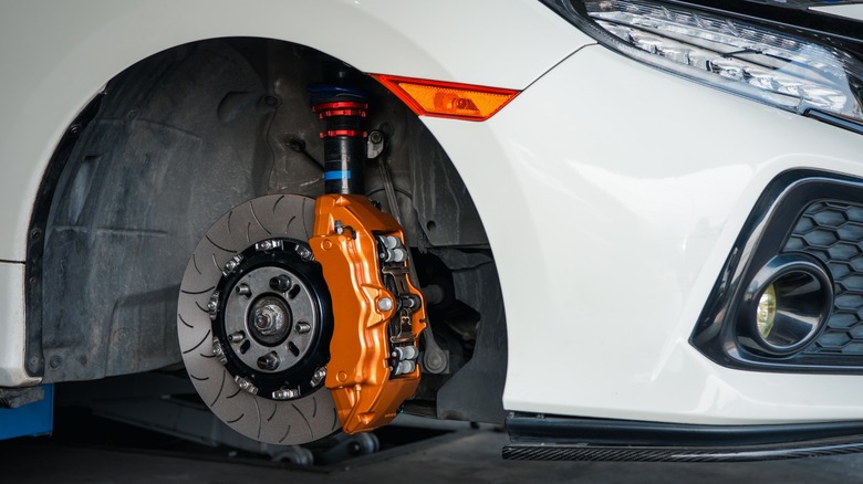 Car's front wheel without the tire exposing brake caliper