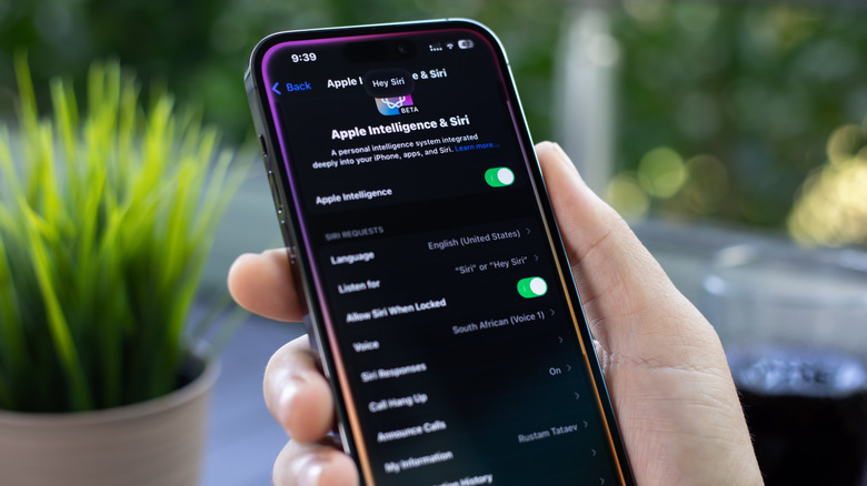 iPhone in hand showing Apple Intelligence screen in dark mod