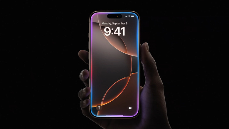 iPhone in hand with screen glowing around the edges