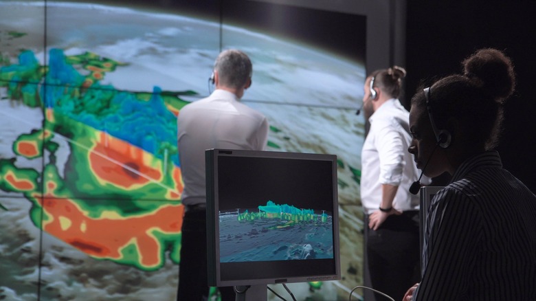 photo of meteorologists analyzing weather