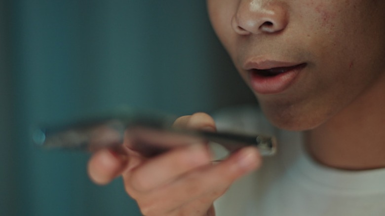 Person talking into mic on phone's bottom