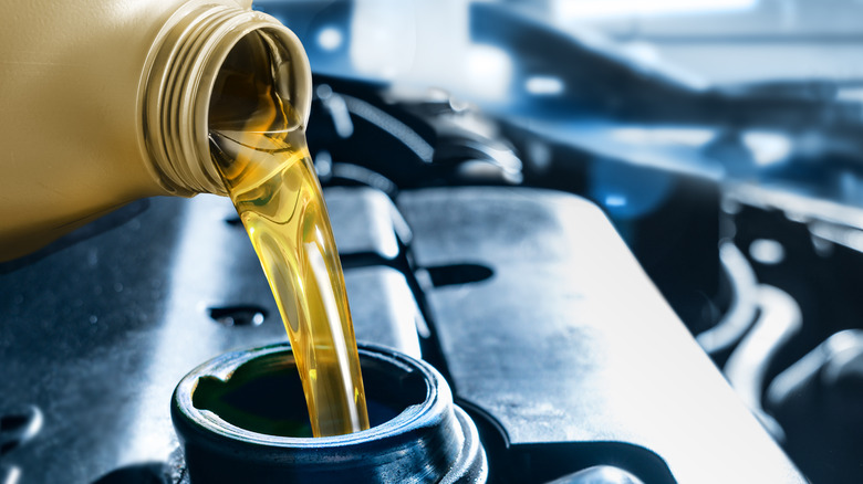 Close up of oil being poured into an engine