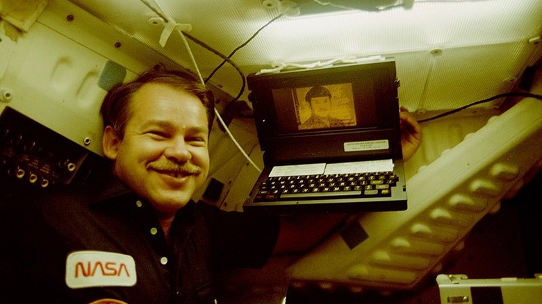 Astronaut holding GRid Compass space shuttle